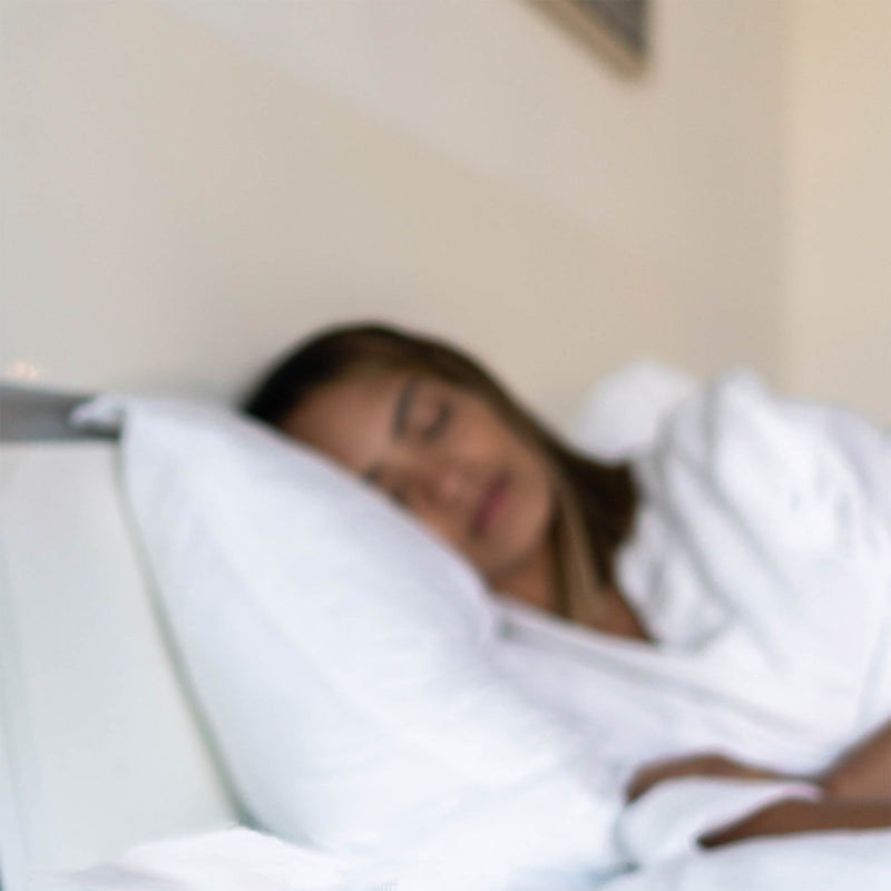 Image of sleeping woman in bed, benefiting from Alurx Sleep Gummies with Melatonin.